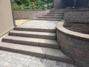 Multi-level brick paver steps, patio and walkway with brick retaining wall